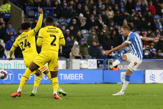 WINNING FEELING: Huddersfield Town's Jordan Rhodes scores his side's second goal against Rotherham United at the John Smith's Stadium. Picture: Barrington Coombs/PA