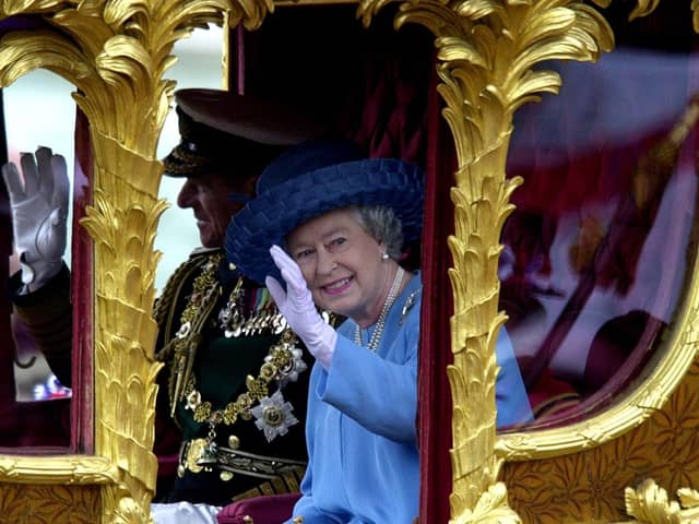 Queen Elizabeth II waves to the crowd as she rides in the Gold State coach from Buckingham Palace to St Paul's Cathedral for a service of Thanksgiving to celebrate to her Golden Jubilee.  PIC: Rebecca Naden/WPA
