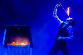 Magician Michael Jordan fire-breathing on stage. Photo by Stephen Lee/Red Box Studios