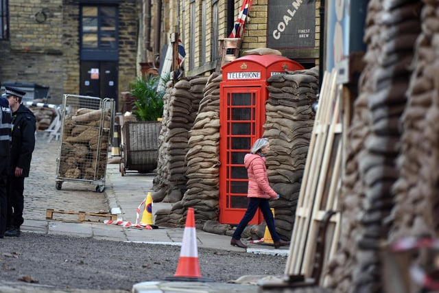 Sandbags are piled up around a red telephone box as Bradford's Little Germany area of former textile warehouses is transformed into bomb-hit 1940s Birmingham streets in preparation for tomorrow's filming. Picture by Asadour Guzelian