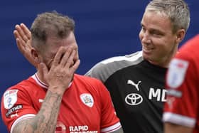 Barnsley manager Michael Duff congratulates scorer James Norwood at the final whistle of the Reds' victory against Sheffield Wednesday at Hillsborough last September. Picture: Steve Ellis