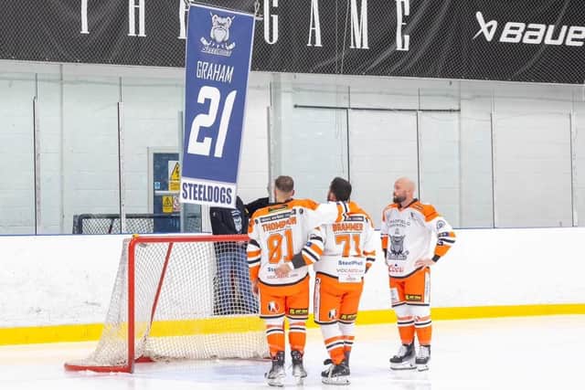 TRIBUTE: Sheffield Steeldogs' Charlie Thompson, Jack Brammer and player-coach Jason Hewitt watch on as the #21 jersey of former team-mate Alex Graham is retired at Ice Sheffield on Sunday. The 20-year-old tragically died suddenly in the summer. Picture courtesy of Peter Best/Steeldogs Media.