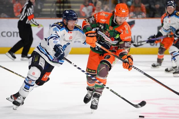 TOUGH TEST: Sheffield Steelers' Mark Simpson (right) battles for puck possession in last week's 2-1 overtime win against Coventry. Picture: Dean Woolley/Steelers Media.