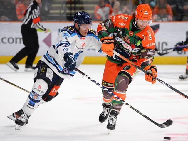 TOUGH TEST: Sheffield Steelers' Mark Simpson (right) battles for puck possession in last week's 2-1 overtime win against Coventry. Picture: Dean Woolley/Steelers Media.