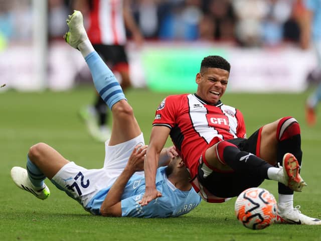INJURY CONCERN: Sheffield United's William Osula (right, playing against Manchester City in August)