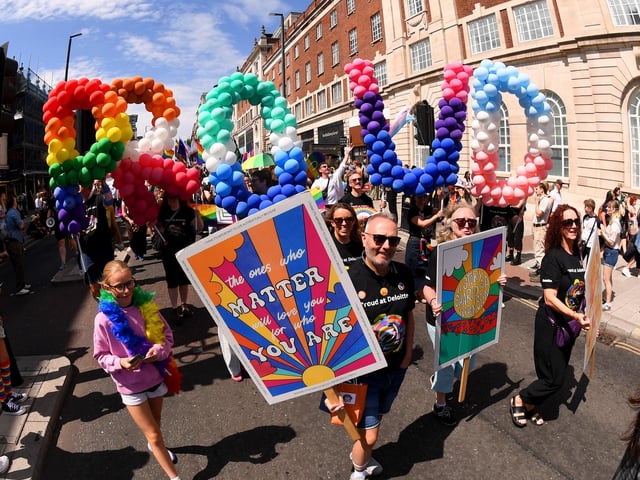 Parade goers marked the milestone celebrations with colourful balloon letters spelling "PROUD"