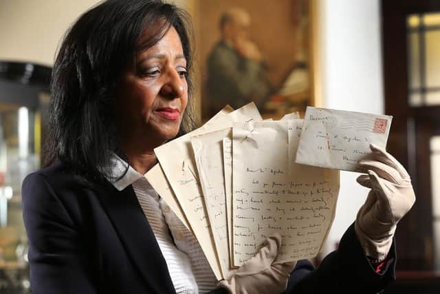 Yvonne Nightingale, general manager of Ogden of Harrogate, holds rare letters of Katharine Woolley to James R Ogden (pictured in background) the Egyptologist who valued Tutankhamun’s gold. (Pic credit: Lorne Campbell / Guzelian Media)
