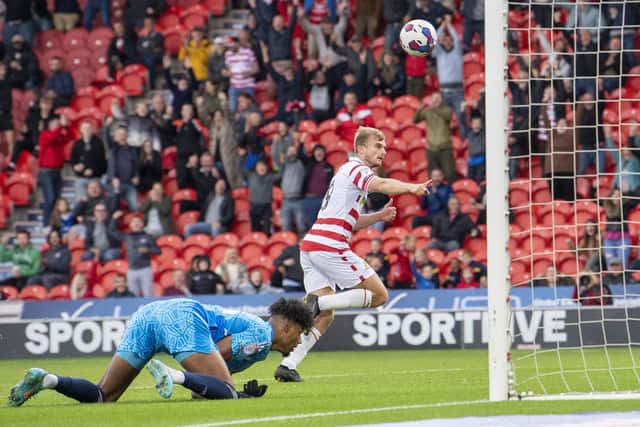 DECISIVE MOMENT: George Miller wheels away scoring his second goal of the game and Doncaster Rovers' third