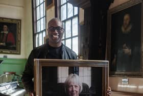 Photographer Ashley Karrell installs the new portrait of Dr Delma Tomlin, the first woman to be appointed Governor of York's Merchant Adventurers’ Hall.