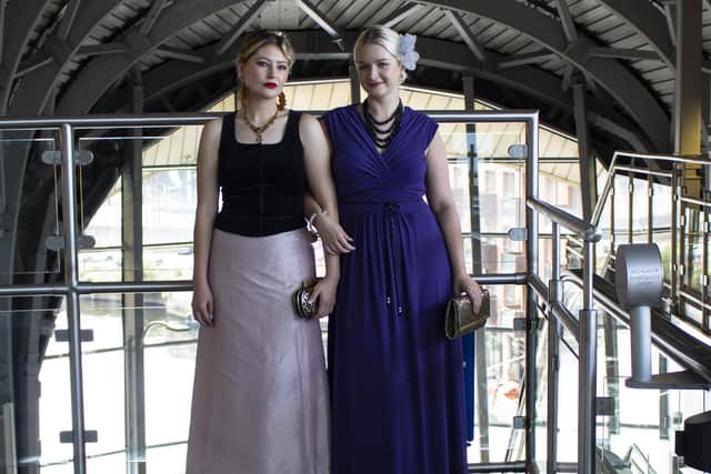 At Leeds Station, Keziah, left, and Penny wear preloved outfits with pieces from Monsoon, Laura Ashley and Phase Eight. Photography: Lottie Roberts | Styling: Stephanie Smith | Styling assistant: Kate Murphy | Models: Penny Hindle and Keziah Kong | Location: Leeds city centre and Leeds Marriott Hotel, Boar Lane, Leeds, marriott.com