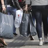 Shoppers carrying bags on the high street. PIC: PA