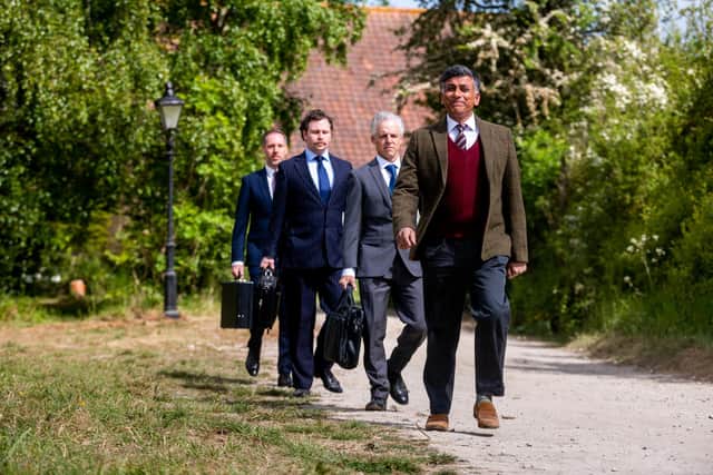 Pictured (front) Actor Ace Bhatti leading a group of office workers during one of the takes at Castle Howard. Picture: James Hardisty.