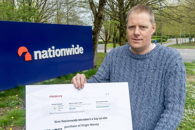 Mikael Armstrong, organiser of the "Give Nationwide Members a say" campaign, outside Nationwide's headquarters in Swindon with a petition calling for the building society to give its 16 million members a vote over its decision to buy rival lender Virgin Money in a deal worth around £2.9 billion. (Photo by Stuart Harrison/PA Wire)