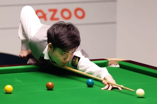 Si Jiahui of China in action against Luca Brecel of Belgium on Day Fourteen of the Cazoo World Snooker Championship. (Photo by George Wood/Getty Images)