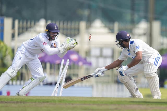 Close, but no cigar: India's captain Rohit Sharma, right, is stumped by England's Ben Foakes, left, on the fourth day of the fourth Test at Ranchi on Monday (Picture: AP Photo/Ajit Solanki)