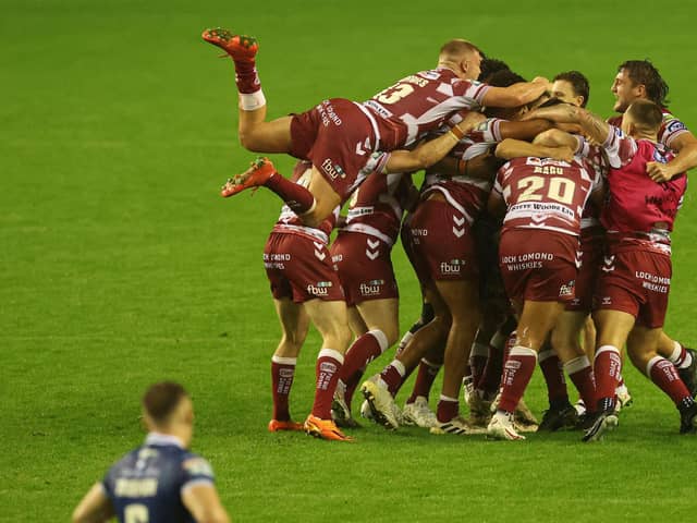 Harry Smith of Wigan Warriors kicks the winning drop goal and golden point  and celebrates with team mates (Picture: Paul Currie/SWPix.com)