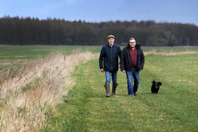 Simon Whitaker with his son Tom and there dog Ted on the gallops Hellwood Farm Hellwood Lane Scarcroft