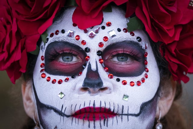 A close up of Ana Franco who is wearing very intricate face paint.