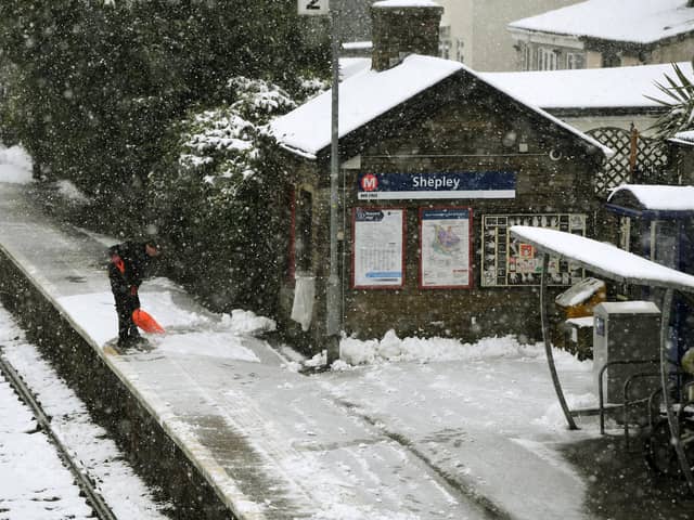 Snow is cleared from the platform at Shepley Railway Station.