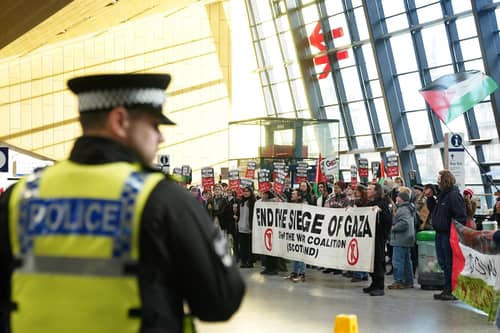 School and university students takes part in a sit down protest in Queen Street station. PIC: Andrew Milligan/PA Wire