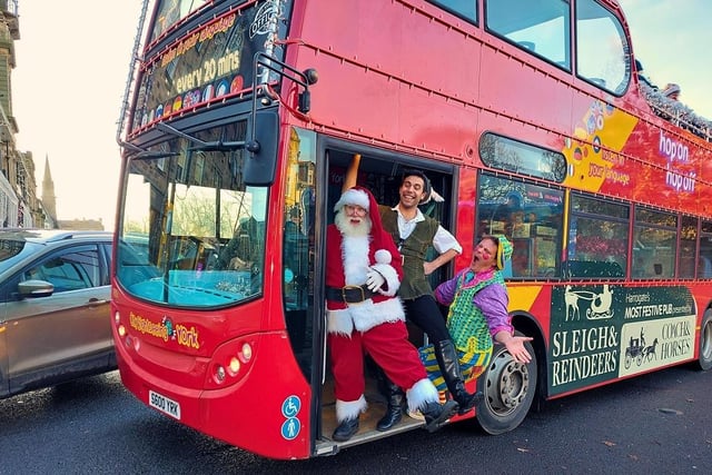 Santa hanging around with two pantomime actors on the Christmas bus.