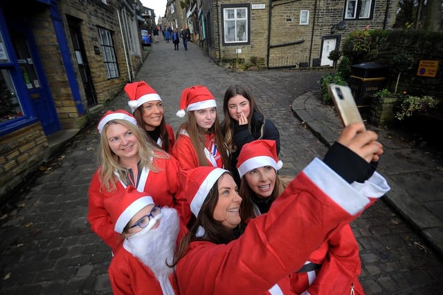 A group of runners take a Santa selfie.