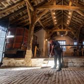 Richard Macfarlane, Calderdale Museums Manager, sweeping the barn at Shibden Hall as they prepare for reopening. Picture Bruce Rollinson.