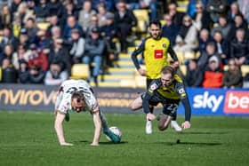 Harrogate Town schemer Stephen Dooley (right) and Bradford City midfielder Kevin McDonald (left) take a tumble on League Two derby day in March. Picture: Tony Johnson.