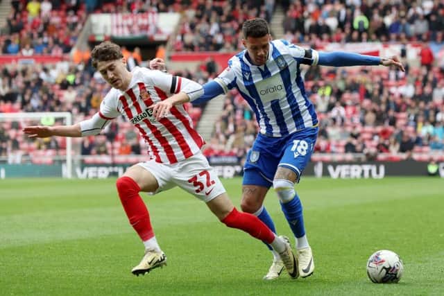 WINGING IT: Marvin Johnson of Sheffield Wednesday controls the ball under pressure from Trai Hume