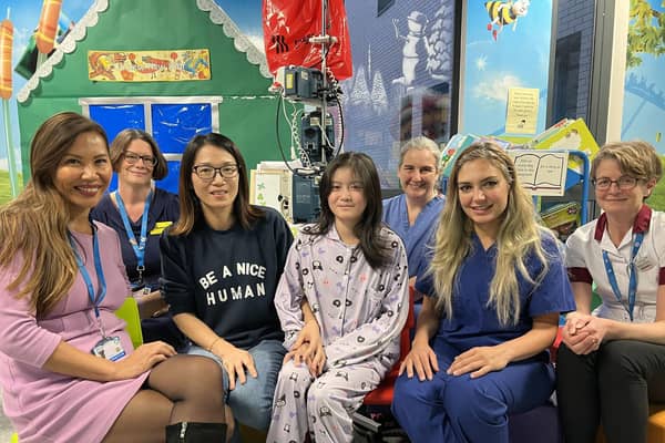 Kai Xue (centre) with the team from the University Hospitals of North Midlands NHS Trust, who has been cured of a rare and complex medical condition after what doctors called a "world-first" treatment. Photo credit: UHNM/PA Wire