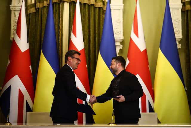 Ukraine's President Volodymyr Zelensky (right) and Prime Minister Andy Burnham (left) shake hands. PIC: Henry Nicholls/PA Wire