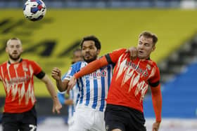 Huddersfield Town's Duane Holmes (left) and Luton Town's James Bree battle for the ball during the Sky Bet Championship match at the John Smith's Stadium. Picture: Richard Sellers/PA Wire.