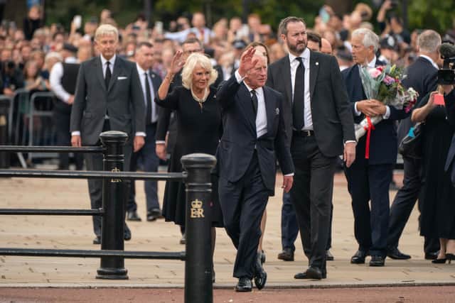 King Charles III and the Queen wave to the crowd outside Buckingham Palace, London after travelling from Balmoral following the death of Queen Elizabeth II on Thursday. Picture date: Friday September 9, 2022.