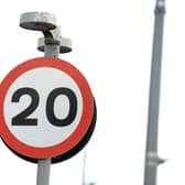 A 20 mph traffic speed sign.