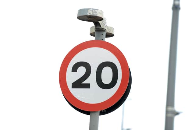 A 20 mph traffic speed sign.