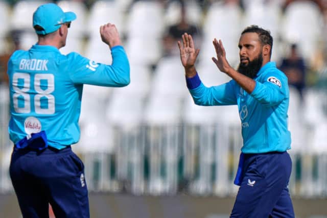 England's Adil Rashid, right, celebrates with teammate after taking the wicket of Pakistan's Salman Ali Agha in Rawalpindi last week. Picture: AP/Anjum Navee