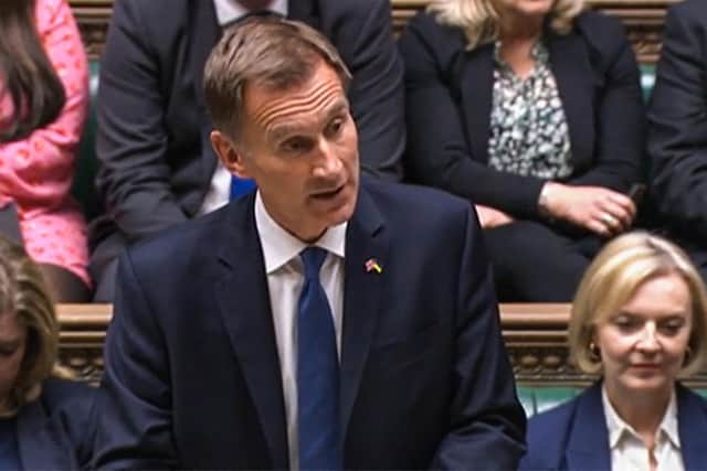 A video grab from footage broadcast by the UK Parliament's Parliamentary Recording Unit (PRU) shows Britain's Chancellor of the Exchequer Jeremy Hunt announcing tax and spending measures, part of medium-term fiscal plan to MPs at the House of Commons, in London, on October 17, 2022. - The British government on October 17, 2022 axed almost all of its debt-fuelled tax cuts unveiled last month to avert fresh markets chaos, in a humiliating climbdown for embattled Prime Minister Liz Truss. The shock move by new finance chief Jeremy Hunt, parachuted into the job on Friday to replace sacked Kwasi Kwarteng, leaves Truss' position in a precarious state after a series of embarrassing U-turns. (Photo by PRU / AFP) / RESTRICTED TO EDITORIAL USE - MANDATORY CREDIT "AFP PHOTO / PRU " - NO MARKETING - NO ADVERTISING CAMPAIGNS - DISTRIBUTED AS A SERVICE TO CLIENTS (Photo by -/PRU/AFP via Getty Images)