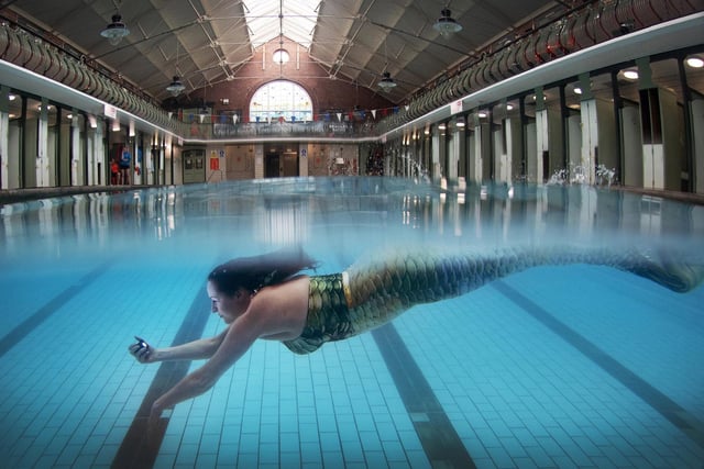 Bramley Baths, Leeds, is the only remaining Edwardian Bath-House in Leeds, and is Grade 11 listed. It first opened as a pool and public bath in 1904 Lucy Meredith dressed as mermaid is part of the Bramley Mermaids Club, swims in the baths. 22nd March 2023