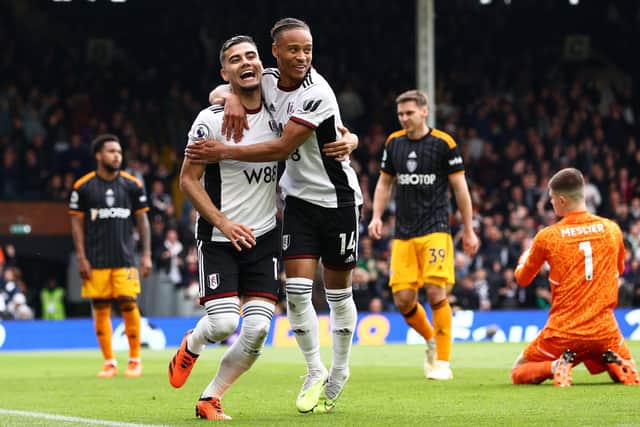 Andreas Pereira of Fulham celebrates with teammate Bobby Reid after scoring the team's second goal leaving Leeds United players dejected (Picture: Clive Rose/Getty Images)