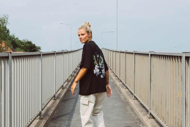 Rachel Daly wears the HERA Limited edition ‘Passion & Courage’ T-shirt featuring designs based on her tattoos and created in partnership with the brand, launching on July 16, costing £46, at heraclothing.com.