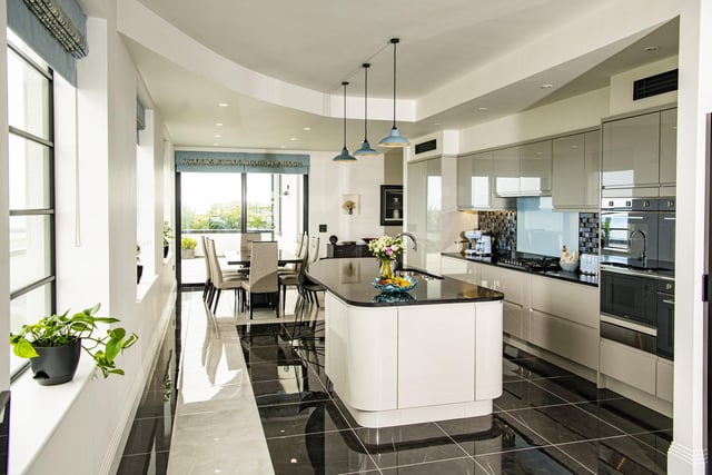 The open plan kitchen and dining area is smart and sleek