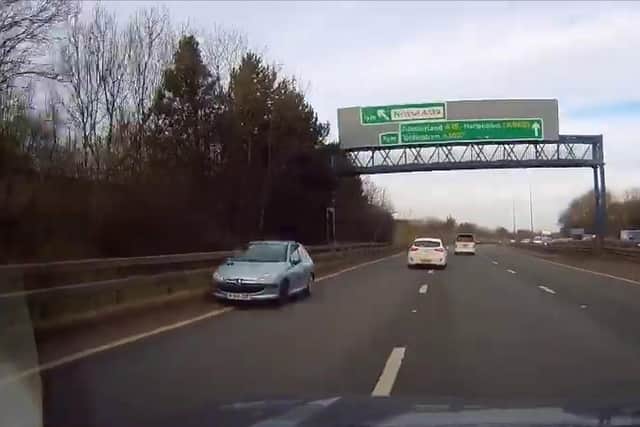 A Peugeot 206 barrelling down the left-hand lane on the A19.