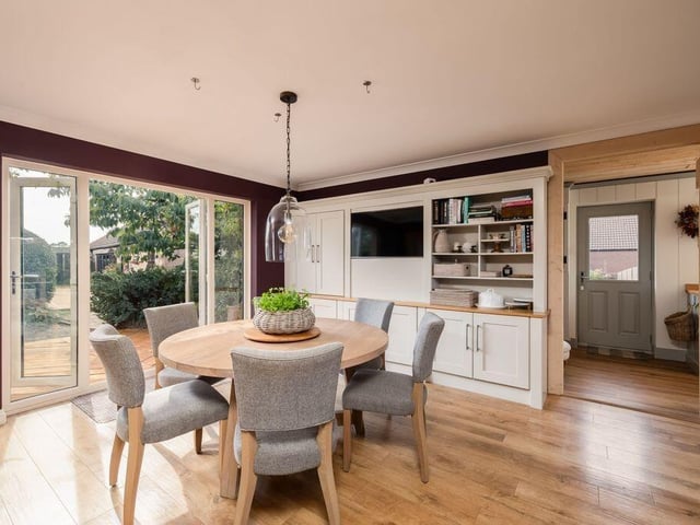 Karndean flooring runs beneath cabinetry, shelving and a generous dining area.