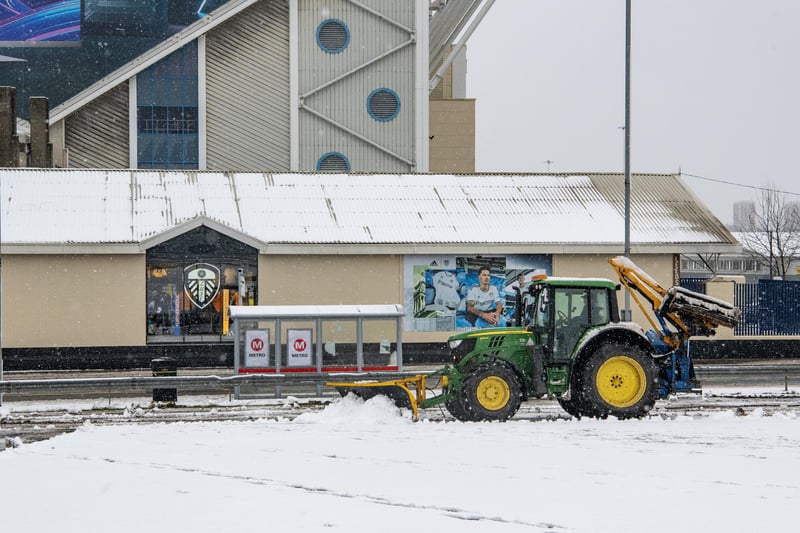 Work to clear the heavy snowfall in the vicinity of Elland Road in preparation for Leeds United's Premier League match with Brighton and Hove Albion