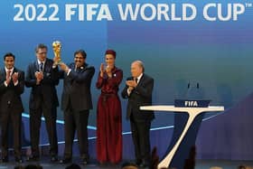 VICTORY CELEBRATION: Qatar's Emir Sheikh Hamad bin Khalifa al-Thani raises the World Cup trophy after then-FIFA president Joseph Blatter announced the country as 2022 World Cup hosts 12 years ago