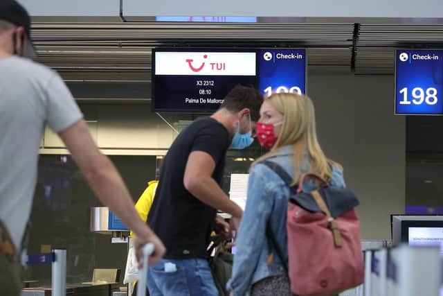Tourists wait to check in for TUI flight. (Pic credit: Andreas Rentz / Getty Images)