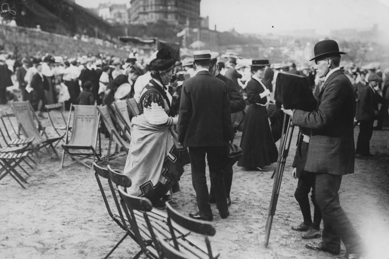 A photographer prepares to take a picture of the judges of the best group of donkeys on Scarborough Sands in 1907.