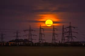 The Hunter's Moon rises above the electricity pylons at the National Grid Substation, west of Monk Fryston.