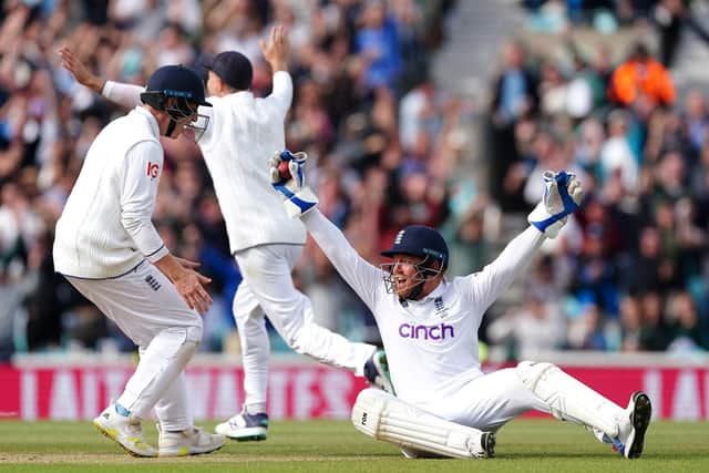 GOT HIM: England's Jonny Bairstow (right) celebrates catching out Australia's Mitchell Marsh on day five at The Kia Oval, London. Picture: Mike Egerton/PA