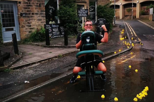 Dean Majors aboard his massage chair in the pool of water outside The Backman in Skipton